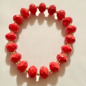 Reddish Orange Faceted Beads with Gold Tone Spacer Beads Stretch Bracelet